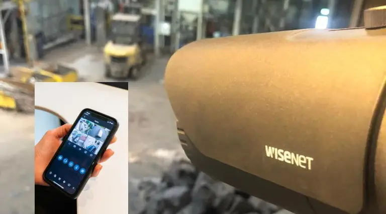 Commercial CCTV camera installed by Safe Simple Secure in a warehouse with images on a smartphone